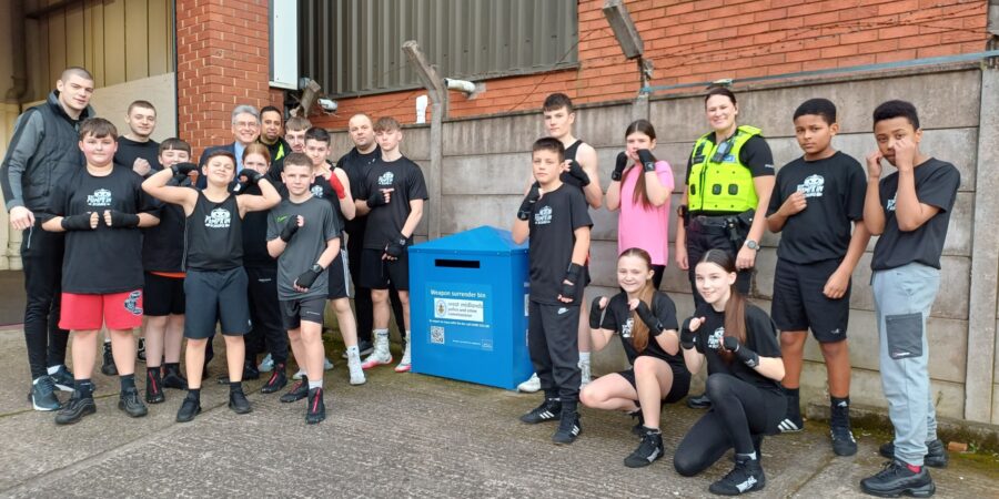 PCC Simon Foster alongside Brierley Hill neighbourhood police officers and the team at Pumpkin Amateur Boxing Club following the installation of the 31st weapon surrender bin