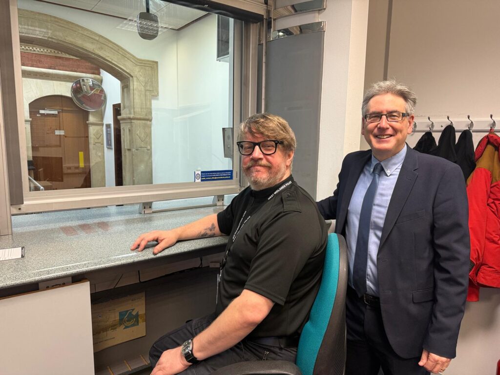 PCC Simon Foster, right, at the front desk at Digbeth Police Station with a member of staff awaiting to speak with members of the public